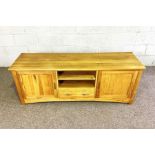 A modern light oak dresser base, with arrangement of niches, cupboards and drawers, 60cm high, 160cm