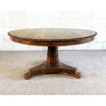 A George IV rosewood breakfast table, circa 1825, with a circular tilt top, set on a pedestal base