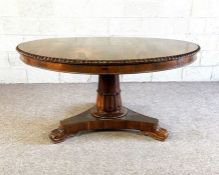 A George IV rosewood breakfast table, circa 1825, with a circular tilt top, set on a pedestal base