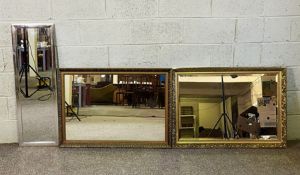 Two gilt framed wall mirrors, modern, with decorative mouldings; together with a modern tall