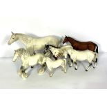 A group of Beswick and Royal Doulton models of horses, including a large Beswick model of a standing