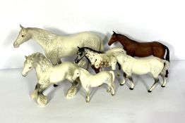 A group of Beswick and Royal Doulton models of horses, including a large Beswick model of a standing
