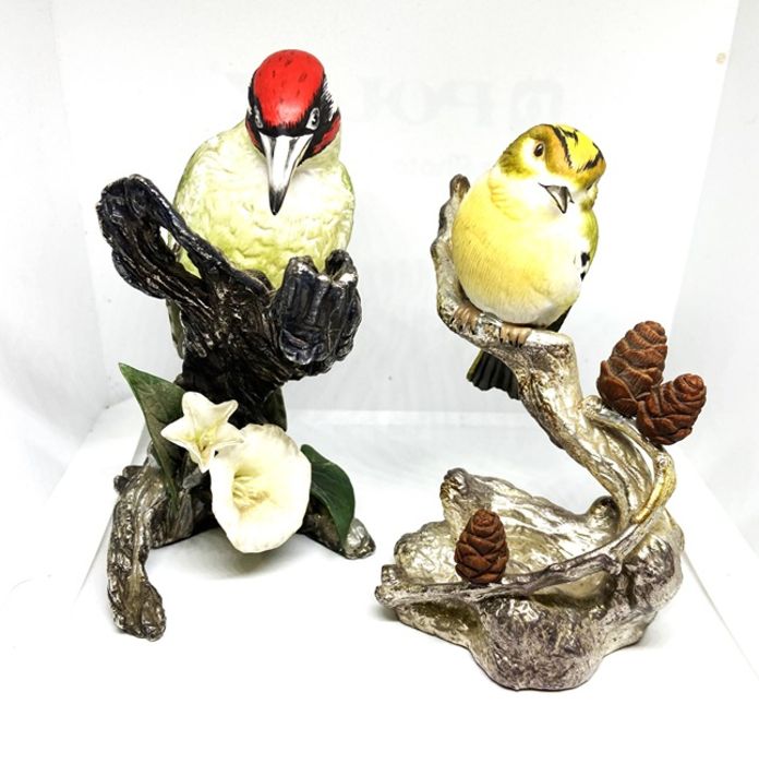 Two ceramic models of birds, 20th century, set on hallmarked silver bases, naturalistically modelled