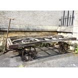 A Victorian cast iron and wood railway luggage and goods hand cart, with steerable front wheels, (in