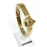 An 18 carat gold Omega ‘Ladymatic’ watch, strap marked British Patent 739748, hallmarked 18 carat,