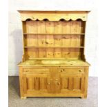 A vintage Lancashire style pine dresser, 20th century, with a two shelf rack, over two drawers and