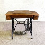A vintage Singer sewing machine and treadle table, with cast iron treadle