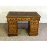 A small Victorian kneehole desk, with an arrangement of nine drawers, 74cm high, 106cm wide; and a