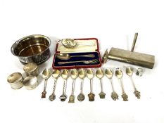 A quantity of silver, including three napkin rings, ten assorted crested tea spoons; also a white
