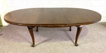 A vintage 'mahogany' extending dining table, 20th century, with oval top and sing leaf, on plain