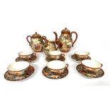 A Japanese porcelain Satsuma tea service, circa 1900, Meiji period, for six place settings,