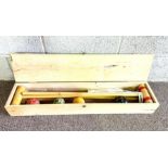 A boxed child’s croquet set, including mallets, hoops and balls (a lot)