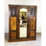 An Edwardian walnut and beech triple wardrobe, with mirrored door and two panelled doors, 200cm