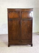 A mahogany veneered double wardrobe, 20th century, with two panelled doors, 181cm high