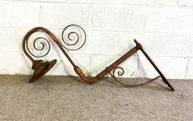 A Victorian hanging wrought iron gas lamp holder, with scrolled support, wall mounted, possibly