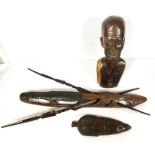 An African carved bust of a man smoking a pipe, hardwood, mid 20th century, 50cm high; together with