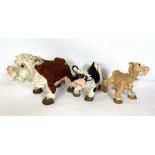 Three large novelty painted resin models of farm animals, including a Holstein cow; a Hereford Bull;