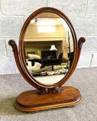 A Victorian mahogany dressing mirror, with an oval hinged plate, on oval plateau base, 84cm high