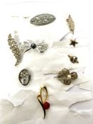 A large assortment of costume jewellery, including brooches, necklaces and ear rings (a lot)