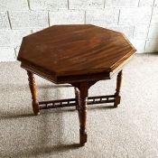 An Edwardian mahogany hexagonal two tier occasional table, circa 1910, with turned legs, united by a