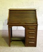 A vintage tambour front oak desk, early 20th century, with a niche and four drawers, 114cm high,