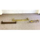 A Victorian brass fire curb, with ball and bar rail, 130cm wide; a set of brass fire irons and
