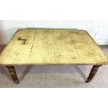 An oak extending dining table, early 20th century, with two additional leaves, and set on turned