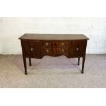 A George III style mahogany bowfront sideboard, circa 1900, with two drawers and two cupboards, on