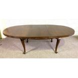 A vintage 'mahogany' extending dining table, 20th century, with oval top and sing leaf, on plain