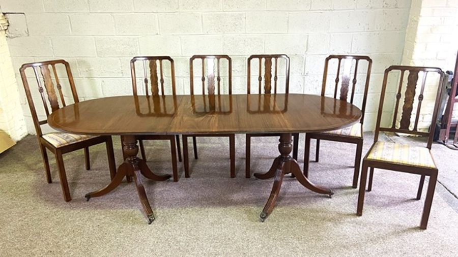 A George III style twin pillar mahogany dining table, modern, with one leaf; together with a set