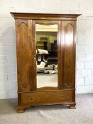 An Edwardian Art Nouveau style wardrobe, with mirrored door and inlaid panels, 198cm high, 136cm