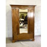 An Edwardian Art Nouveau style wardrobe, with mirrored door and inlaid panels, 198cm high, 136cm