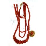 A group of coral cabochon jewellery, including a double string necklace with yellow metal clasp; a