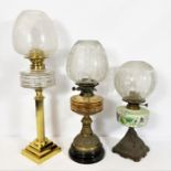 Three vintage oil lamps, all with glass globes (3)