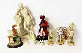 An assortment of decorative ceramic figures, including a Royal Doulton Flambé figure of The Lamp