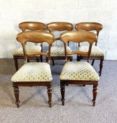 A set of six Victorian mahogany dining chairs, with rounded backs and stuffed over seats on turned