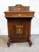 A late Victorian rosewood Davenport, circa 1890, of typical form, with stationary box over a