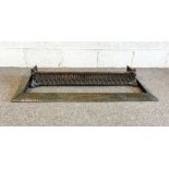 An Arts & Crafts beaten copper fire curb; together with a Victorian cast iron decorative fire