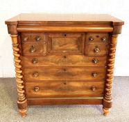 A large Scottish Victorian mahogany chest of drawers, with a cushion drawer above a central hat