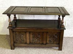 A vintage 17th century style oak monks bench, 20th century, with panelled hinged top, 75cm high,