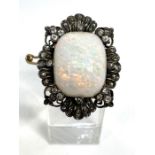 A fine vintage white opal cabochon and diamond brooch, circa 1910, with a large solid finely