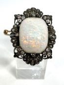 A fine vintage white opal cabochon and diamond brooch, circa 1910, with a large solid finely
