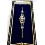 A vintage diamond bar brooch, retailed by Hemmings Ltd, London, with a cluster of old round cut