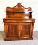 A Victorian mahogany chiffonier, circa 1860, with arched galleried back and a shelf, over a