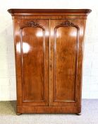 A mid Victorian mahogany compactum double wardrobe, circa 1870, with moulded cornice over two arch