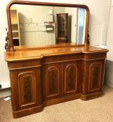 A mid Victorian mahogany sideboard, circa 1860, with a mirrored back with scroll carved crest and