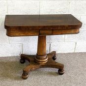 An attractive William IV rosewood card table, circa 1830, with a fold-over rotating top, baize lined