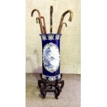 A blue and white Victorian decorative stick stand, decorated with panels of flowers; together with