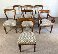 A set of six Victorian mahogany balloon backed dining chairs, and an associated armchair, mid 19th