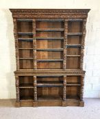 A large Victorian oak Jacobean style open bookcase, the top with three flights of adjustable
